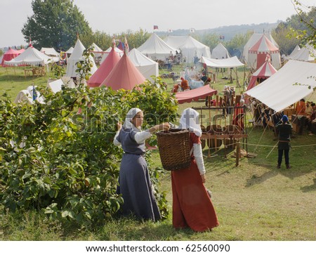 TERRA DEL SOLE,  ITALY - OCTOBER 3: unidentified women picking apples in medieval camp  \
