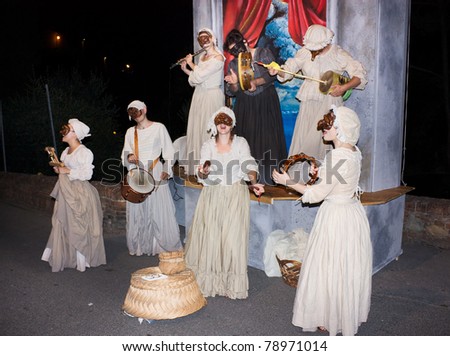 CERTALDO, ITALY - JULY 15: Unidentified men dressed as women with Pulcinella mask perform a musical show and sing a Neapolitan song in \