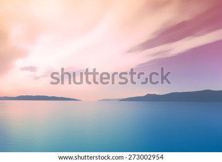 instagram style subtle blurry summer background landscape with trendy colorful filter overlay. Blue ocean with hills and mountains in the distance on a warm pink sunset