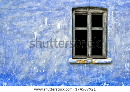 Decaying blue wall & dark window