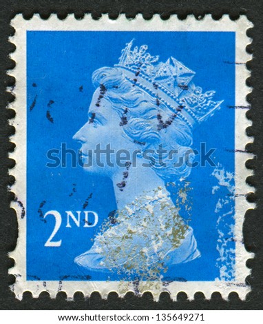 UK-CIRCA 1989:A stamp printed in UK shows image of Elizabeth II is the constitutional monarch of 16 sovereign states known as the Commonwealth realms, in blue, circa 1989.