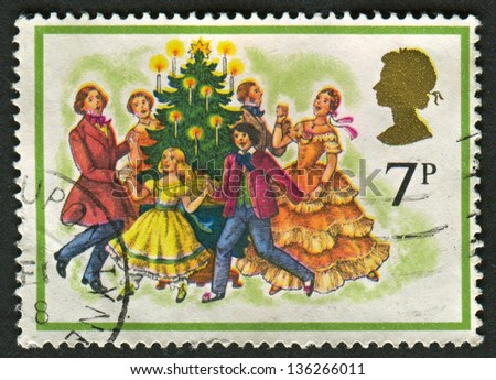 UK - CIRCA 1978: A stamp printed in UK shows image of The Singing Carols round the Christmas Tree, circa 1978.