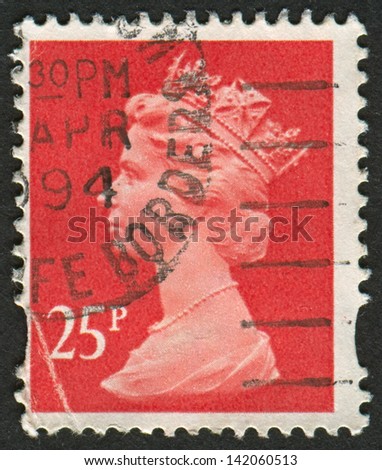 UK-CIRCA 1993: A stamp printed in UK shows image of Elizabeth II is the constitutional monarch of 16 sovereign states known as the Commonwealth realms, in Rose Red, circa 1993.