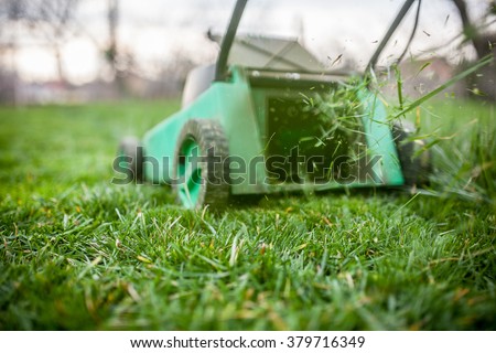Grass cutting with lawn mower.