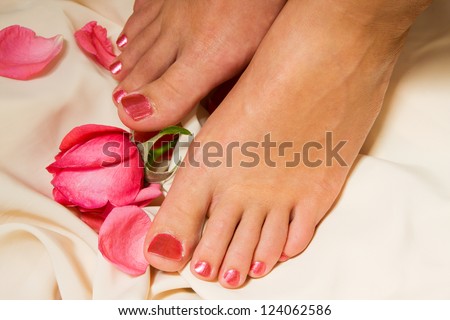 Woman pedicure arranged with rose and leafs