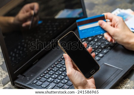 Woman is using credit card and mobile phone for on line payment. mobile shopping concept