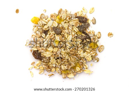 Heap of muesli isolated on white. Delicious granola cereal mix, with dried fruit and seeds.