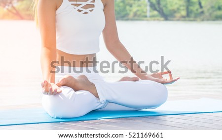young yoga -relax in the park , with sun light.