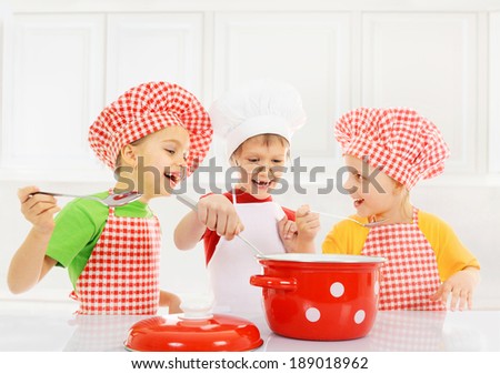 Funny children cooking in the kitchen