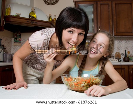 Mother and daughter prepare a salad