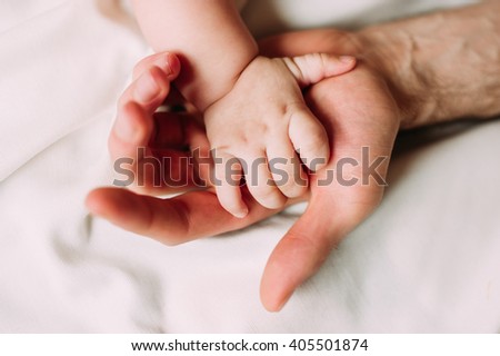 Portrait of loving father with baby boy 4-6 months his son at home on white