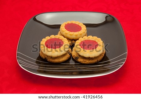 A plate of cookies on red background