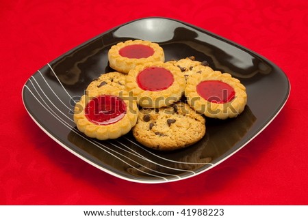 A plate of cookies on red background
