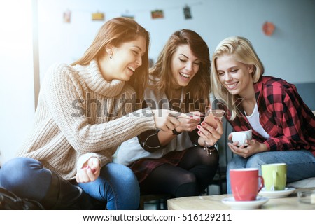 Three beautiful friends in a cafe.