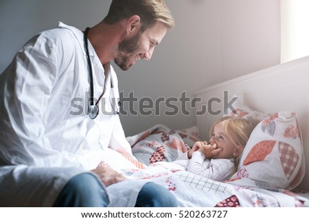 Young male doctor visiting his little patient in hospital.