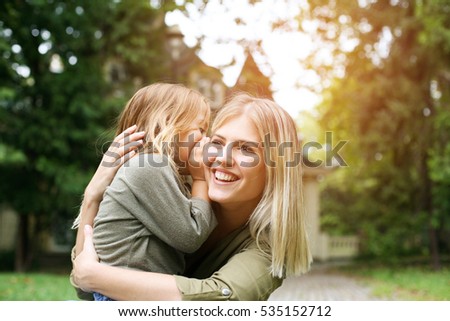 Daughter whispering into her mother.