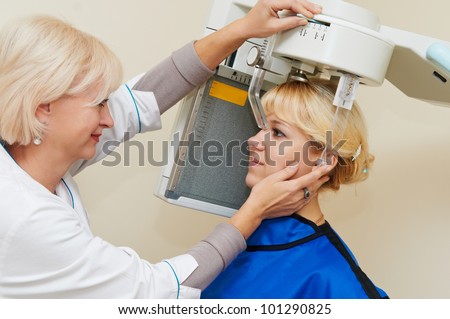 digital system equipment for dental teeth diagnostic examination with patient woman in protective clothes