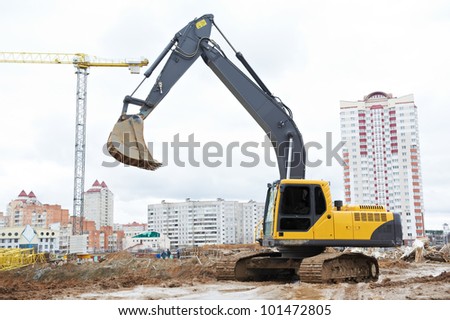 track-type loader excavator machine doing earthmoving work at sand quarry in construction building area