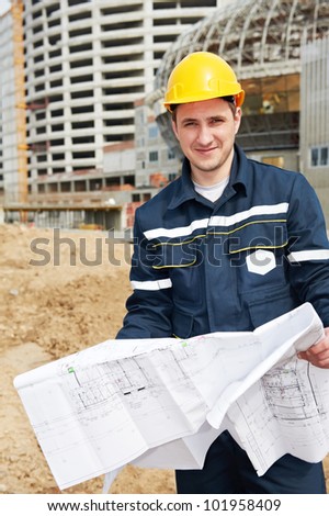One happy engineer builder foreman with blueprint plan working deawing at construction site