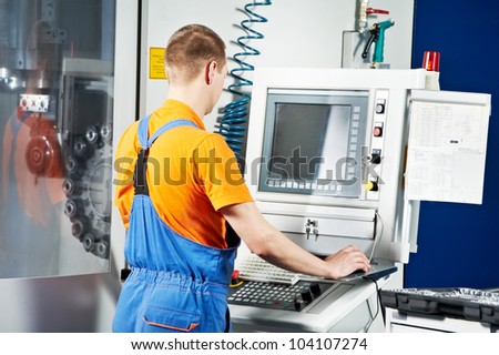 mechanical technician near cnc milling machine center at tool workshop