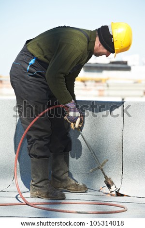  Roofing felt with heating and melting roll of bitumen roll by torch on