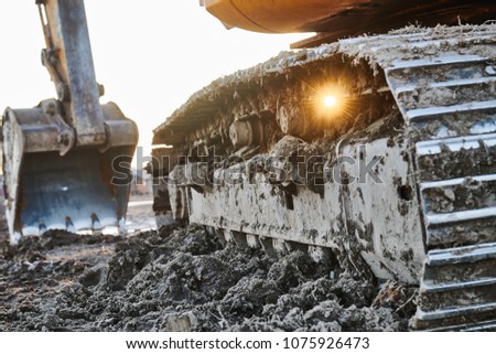 excavation work. Excavator at construction site with sunset