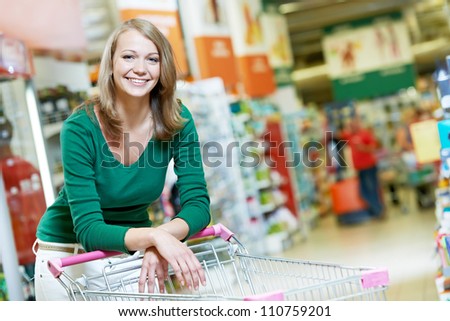 One happy women with shopping cart at supermarket shopping mall store