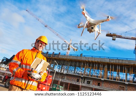 Drone operated by construction worker on building site