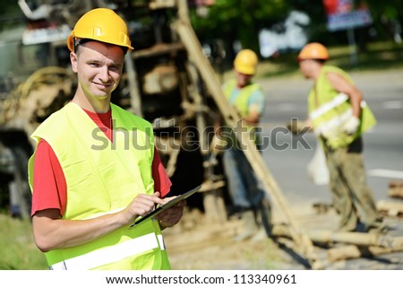 One happy smiling engineer site manager builder with tablet PC at geology roadwork construction site