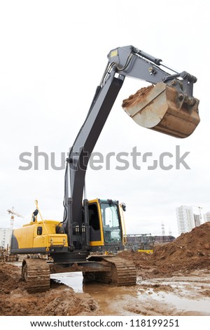 track-type loader excavator machine doing earthmoving work at sand quarry