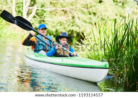 Kayaking on river in forest. Family on canoe. Active recreation and vacation