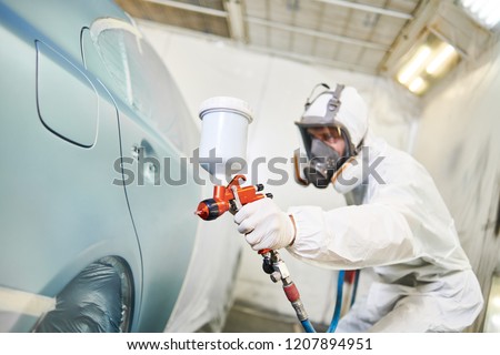 car painter with painting gun in chamber