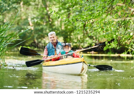 Kayaking on river in forest. Family on canoe. Active recreation and vacation