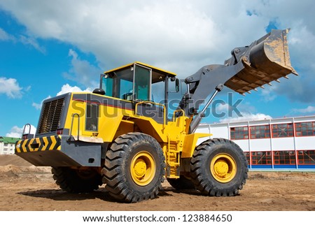 heavy wheel loader excavator machine loading sand at quarry