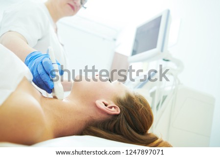 ultrasound scan. Examining the thyroid gland of female patient