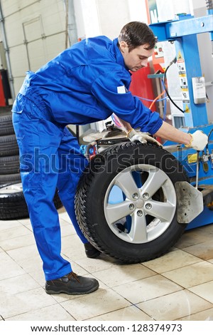 mechanic repairman balancing automobile car wheel on balancer mechanic repairman balancing automobile car wheel on balancer