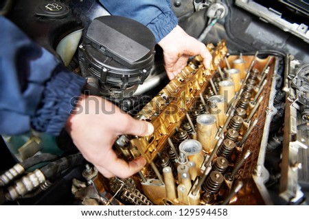 mechanic repairman at automobile car engine maintenance repair work