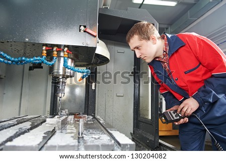 mechanical technician worker of cnc milling cutting machine center at tool workshop manufacturing