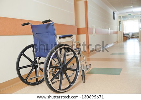 Wheelchair for patient moving standing in corridor of modern cardiology clinic hospital