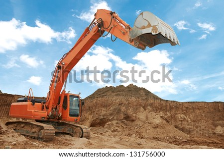 track-type loader excavator machine doing earthmoving work at sand quarry