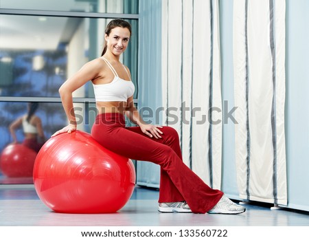 woman with fitness ball in gym at physical training in sport wear