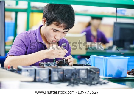 One Chinese Worker Assembling Production At Line Conveyor In China Factory