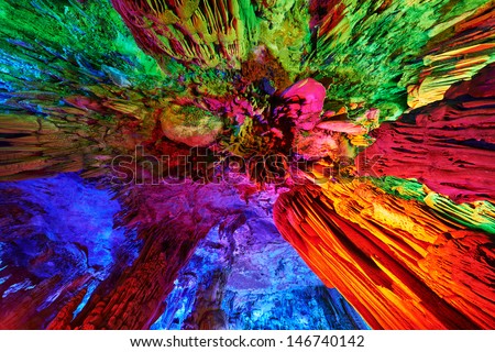 beautiful illuminated multicolored stalactites from karst Reed Flute cave. Guilin Guangxi China