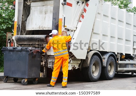Worker Of Urban Municipal Recycling Garbage Collector Truck Loading Waste And Trash Bin