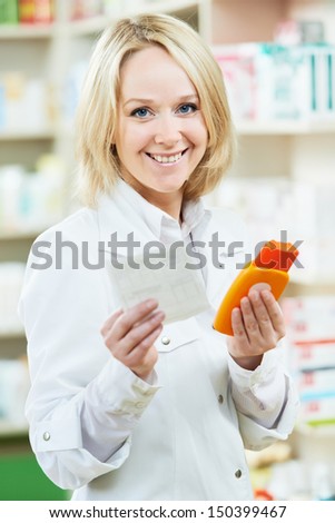 Smiling female pharmacist woman working in pharmacy drugstore