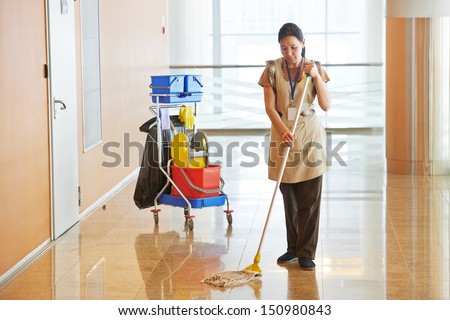 Female Cleaner Maid Woman Worker With Mop In Uniform Cleaning Corridor Pass Or Hall Floor Of Business Building