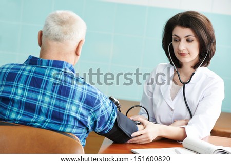doctor nurse measuring blood pressure of patient by phonendoscope in clinic hospital