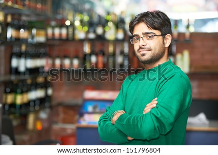 Portrait of Indian sikh man seller with bushy beard at shop
