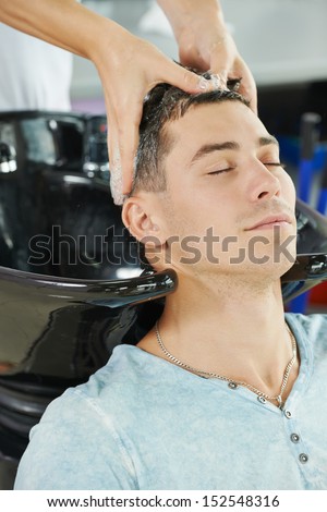 Washing Man Client Hair In Beauty Parlour Hairdressing Salon