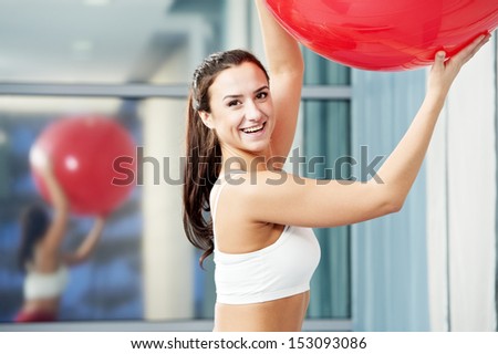 woman with fitness ball in gym at physical training in sport wear